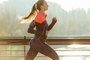 healthy-woman-running-with-blurred-background_23-2147600427